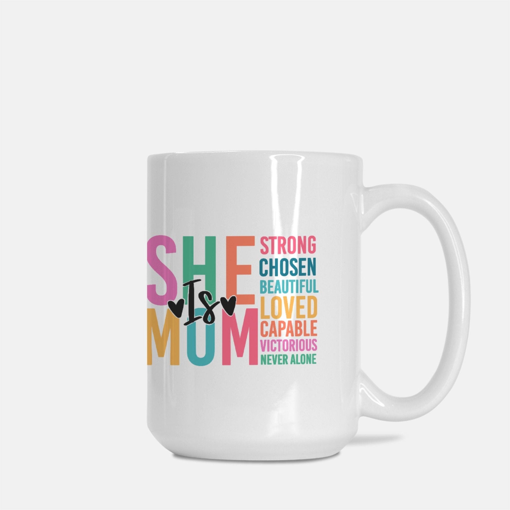 She Is MOM coffee mug on white background. Pastel letter